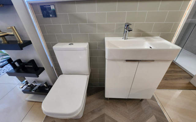 Stylish white close-coupled toilet and basin unit with modern design.
